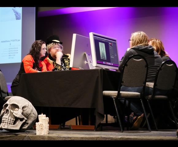 People looking at graphic design on computer