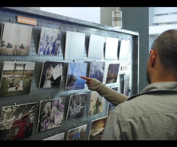 People grabbing magazines off of shelf