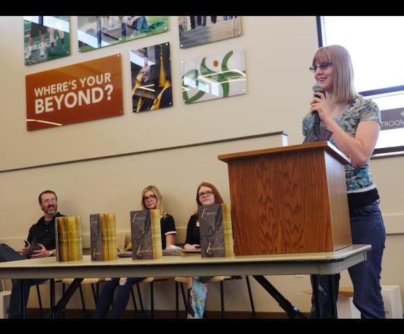 Women at podium speaking with microphone
