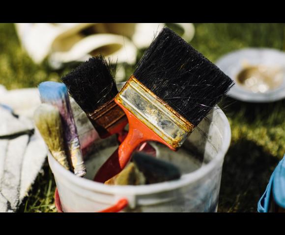 Bucket with paint brushes
