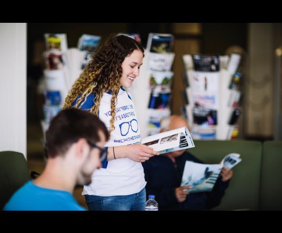 Person reading to others out of textbook