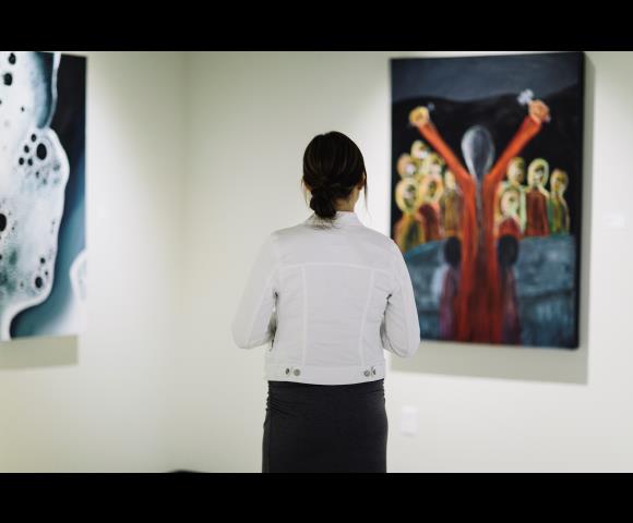Person looking at Art pictures on the wall